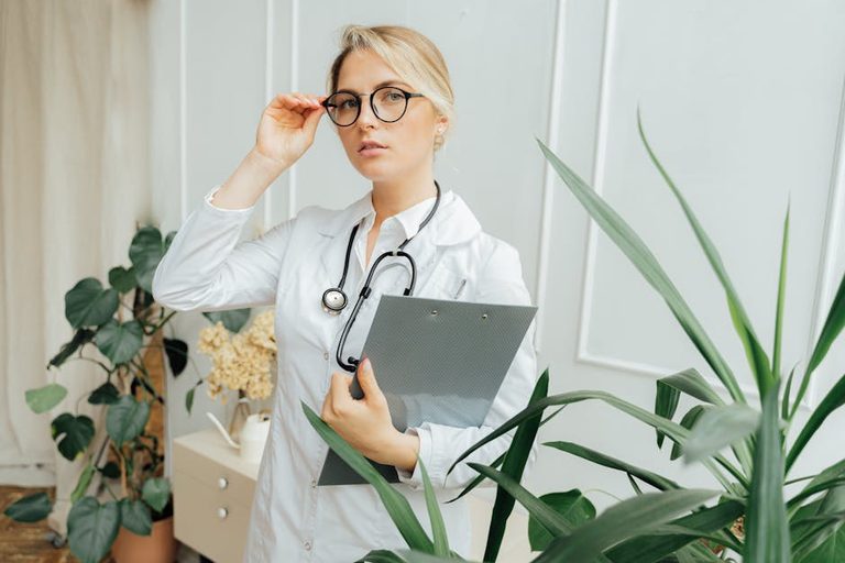 confident-female-doctor-wearing-eyeglasses-and-holding-a-cli