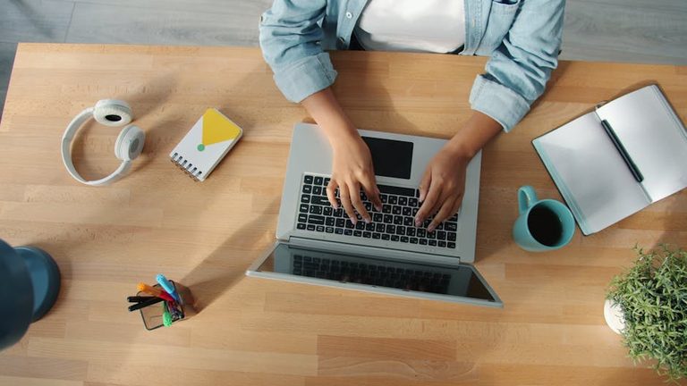 top-down-view-of-a-person-working-on-a-laptop-at-a-neat-desk